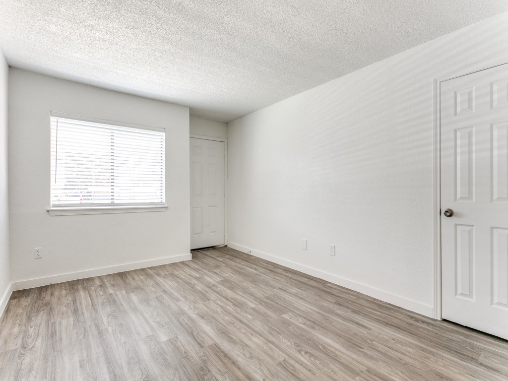 a bedroom with a door and a window