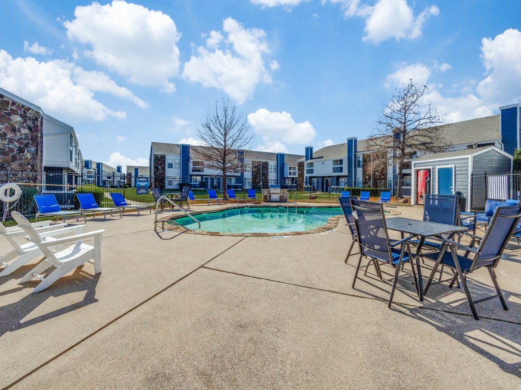 our apartments offer a pool and patio with chairs and tables