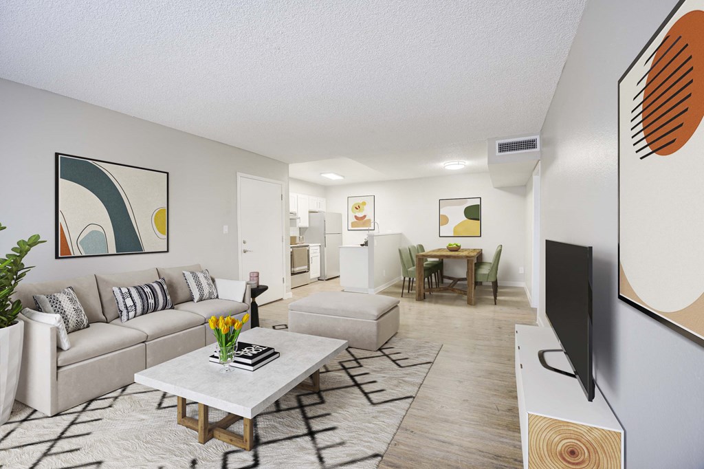 our apartments offer a living room with a couch a coffee table and a flat screen tv