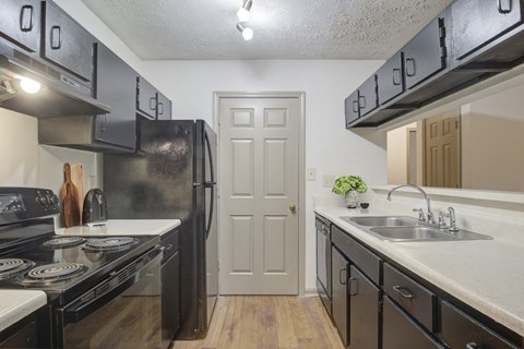the preserve at ballantyne commons apartment kitchen with black appliances and white counters