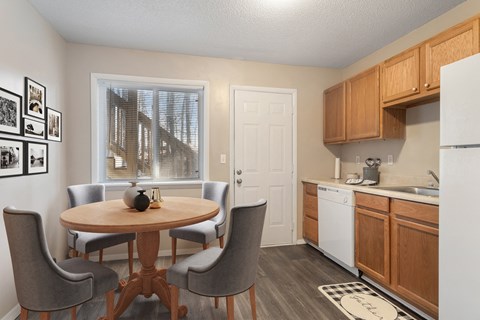 a kitchen and dining room with a table and chairs