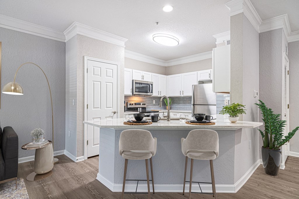 Spacious kitchen with stainless steel appliance package, eating area, and ample cabinet space at The Asher at Sugarloaf, a pet-friendly community in Lawrenceville, GA, near Duluth.