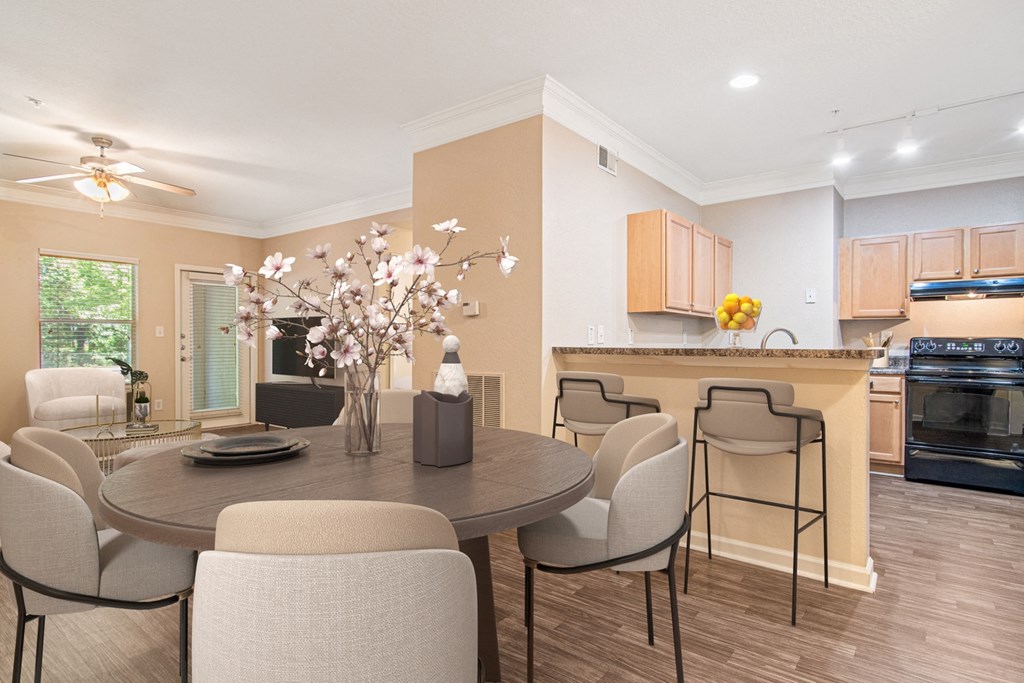 Living room adjacent to the kitchen at The Asher at Sugarloaf, a pet-friendly community in Lawrenceville, GA, near Duluth.