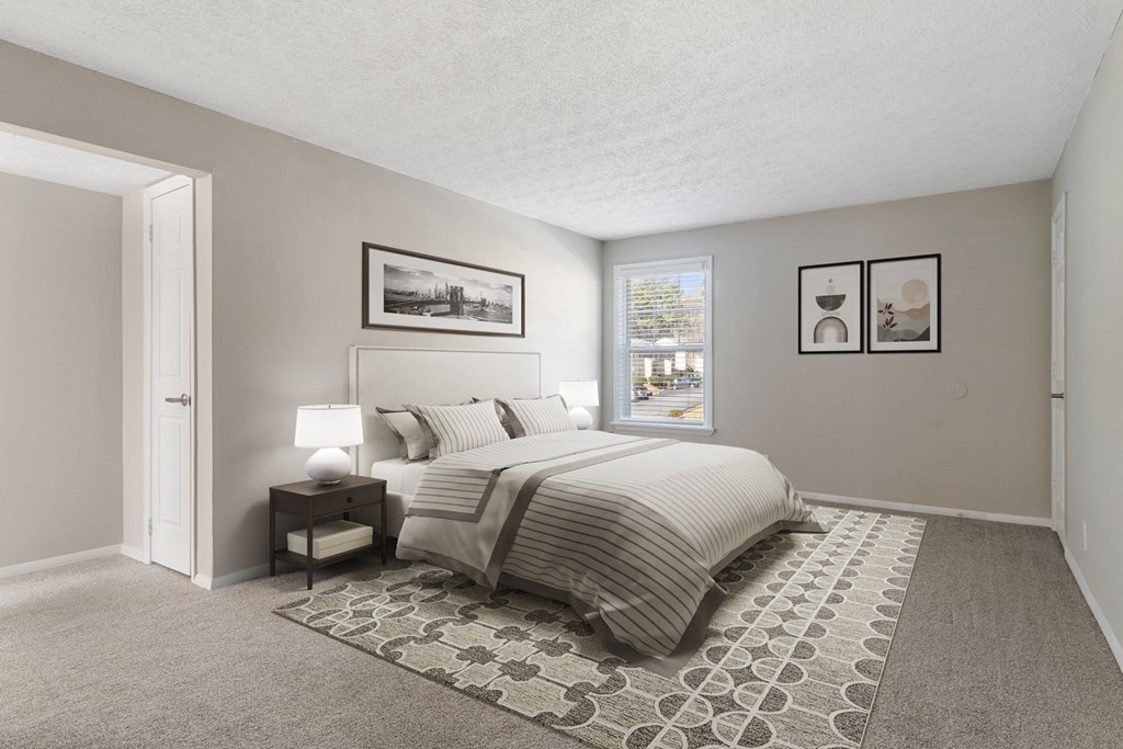 Bedroom with large window and soft plush carpeting at Mableton Ridge Apartments in Mableton, GA, near Douglasville.