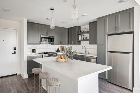 a kitchen with stainless steel appliances and a white counter top