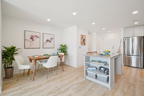 A kitchen with a table and chairs in the middle of the room.