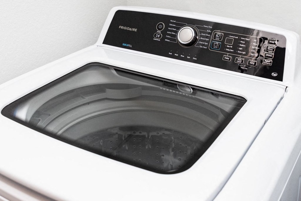 a white washing machine with the door open