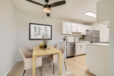 Spacious pet-friendly apartment dining area with ceiling fan at Aurora Meadows near Green Valley Ranch