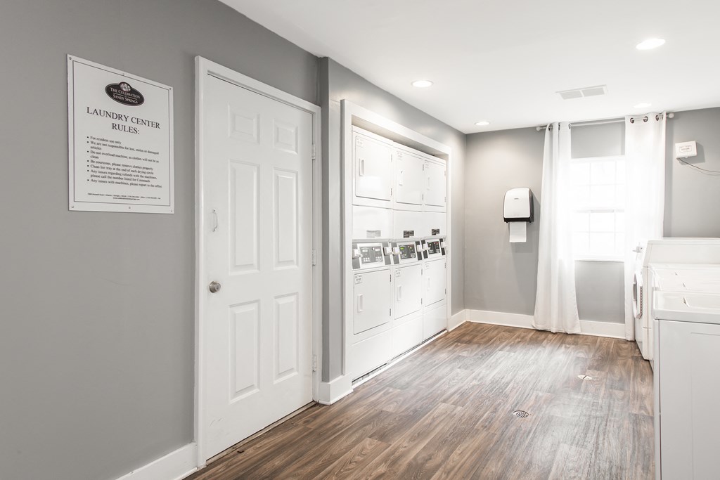 Apartments In Sandy Springs, GA for Rent – Celebration at Sandy Springs - a laundry room with white doors and gray walls