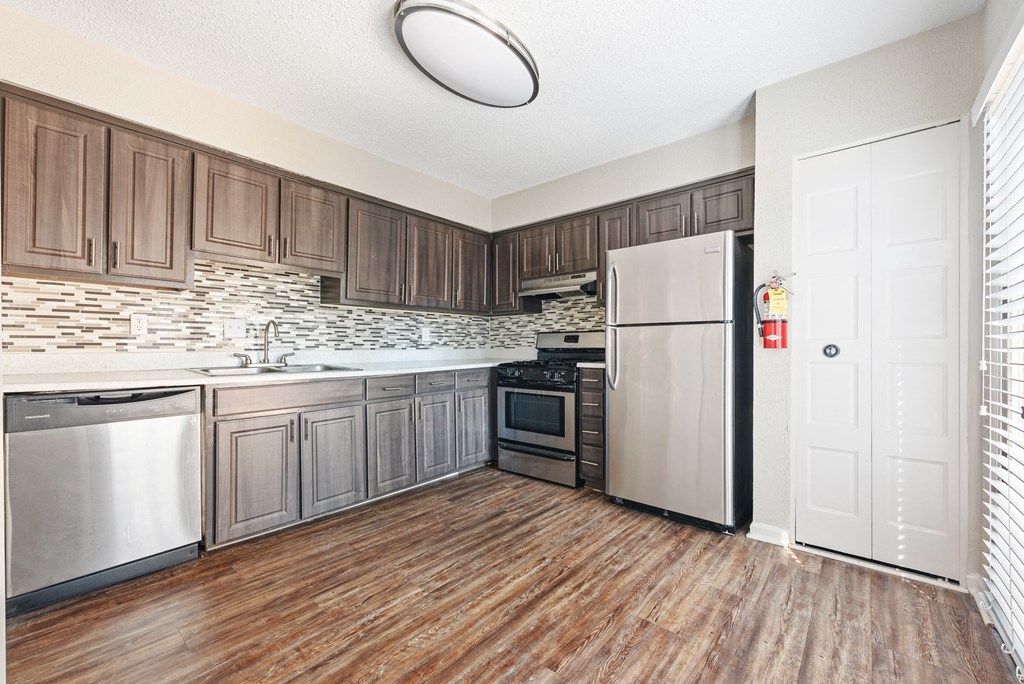 Mirador at Idlewood Apartments in Clarkston Georgia photo of view of kitchen with hardwood floors and stainless steel appliances