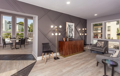 A modern living room with a wooden coffee table and grey sofa.