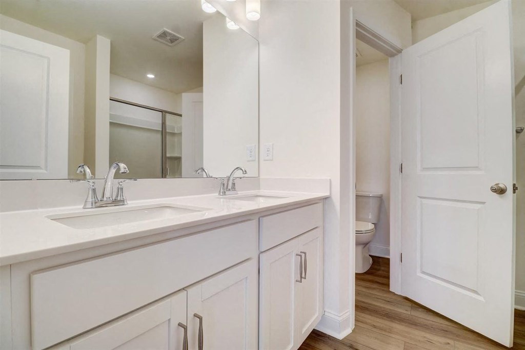 a bathroom with two sinks and a toilet