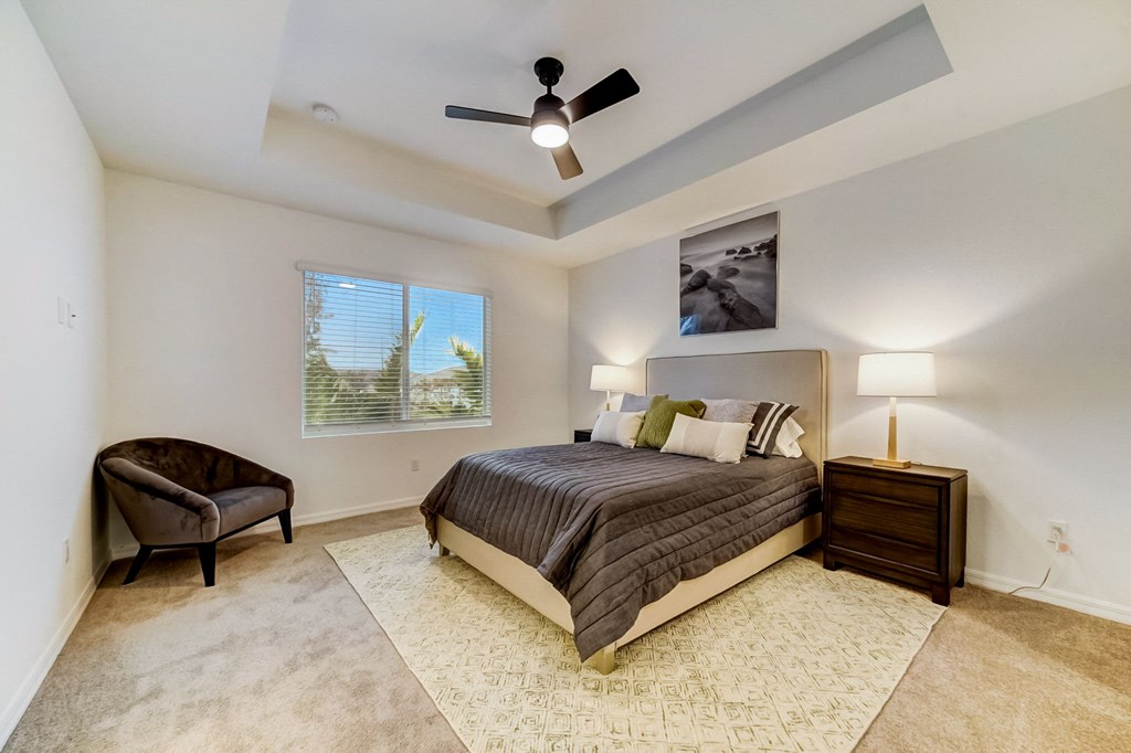 Boatman Hammock Townhomes in Lake Worth, FL photo of  a bedroom with a large bed and a ceiling fan