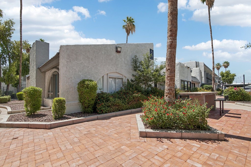 A house with a palm tree in front.