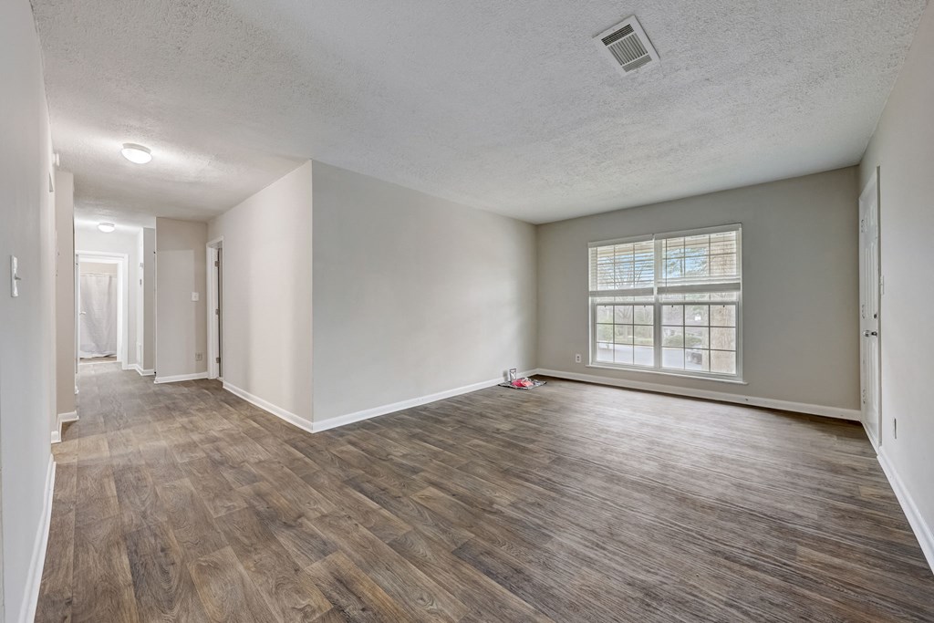 Pet-Friendly Apartments in Sandy Springs – Celebration at Sandy Springs - empty living room with hardwood floors and large windows