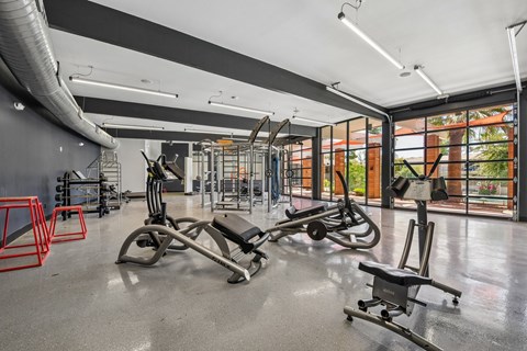 A gym with a variety of equipment including a leg press machine.