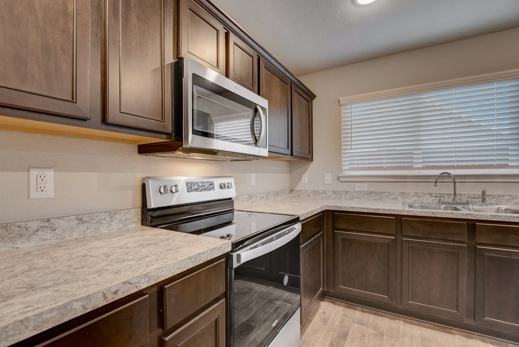 the kitchen of a home with stainless steel appliances and marble counter tops