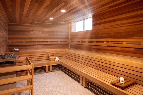 a wooden sauna with benches and a table