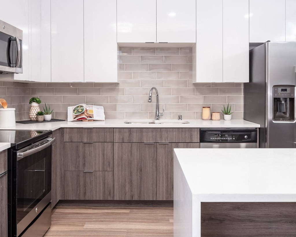 a kitchen with white countertops and wooden cabinets