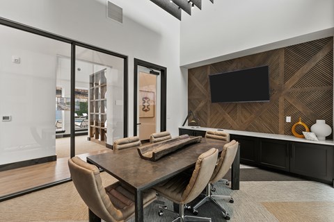 A conference room with a wooden table and chairs.