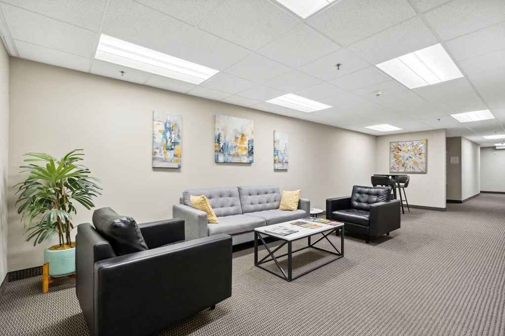 a room with couches and chairs and a table