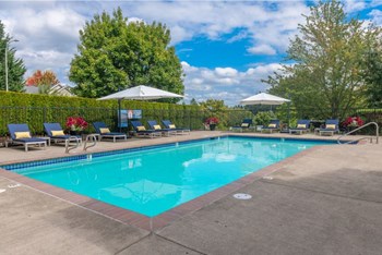 Tigard OR Apartments - Bull Mountain Heights - Swimming Pool Surrounded by Lounge Seating and Lush Landscaping - Photo Gallery 4