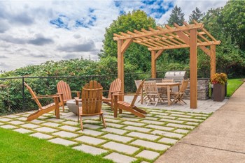 Apartment Tigard OR - Bull Mountain Heights - BBQ Area with Grill Station, Patio Dining Area, and Lounge Seating Surrounding a Firepit - Photo Gallery 5