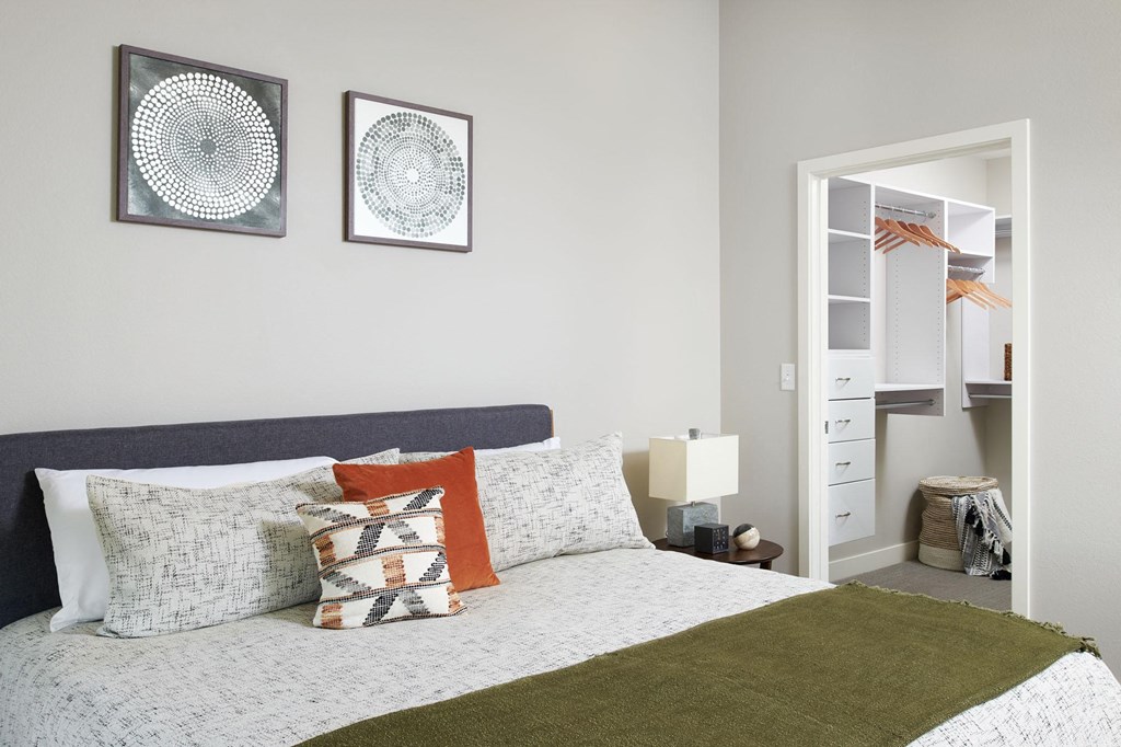 a bedroom with a bed and two pictures on the wall