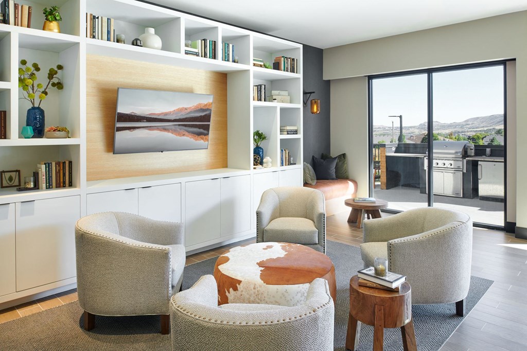 a living room filled with furniture and a large window