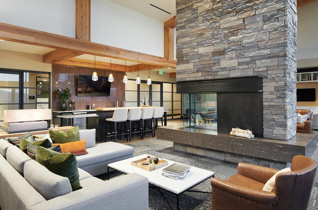 a living room filled with furniture and a large fireplace