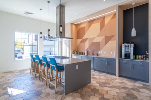 a large kitchen with blue chairs and a counter top