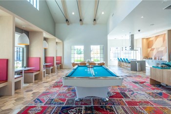 a pool table sits in the middle of a room with a bar in the background - Photo Gallery 7