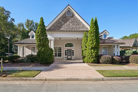 A house with a grey roof and a brick walkway in front.