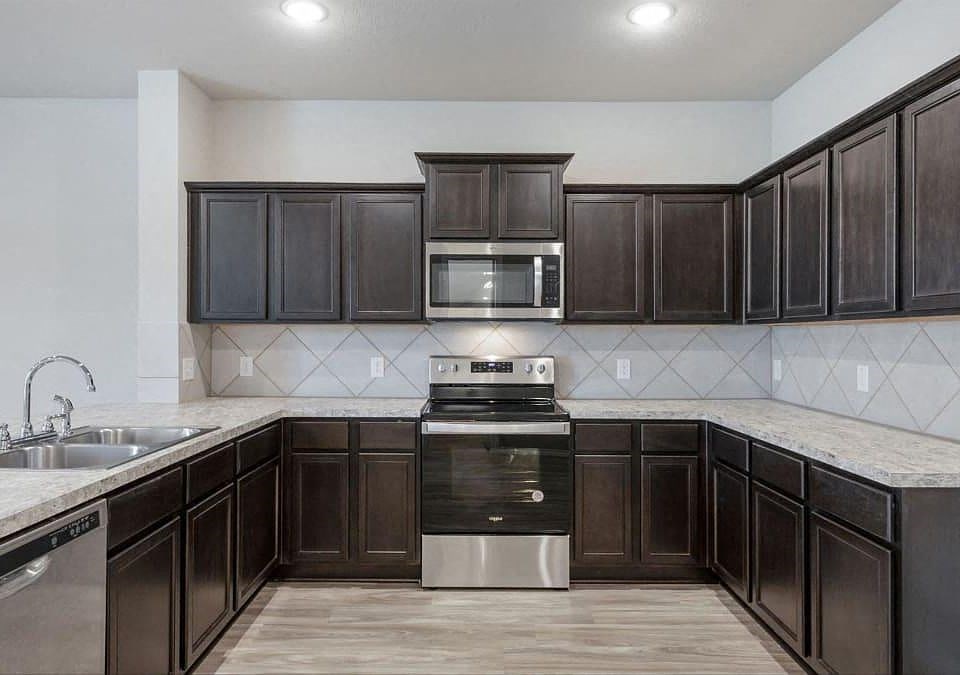 a kitchen with a stove and a sink