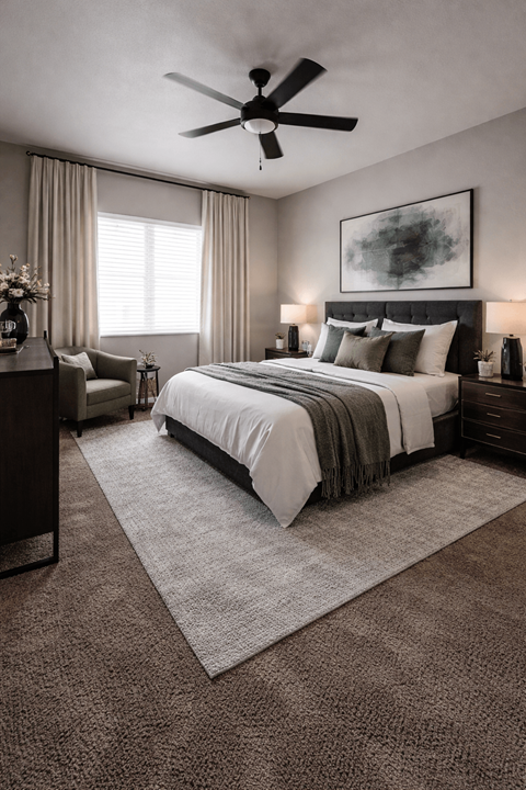 A bedroom with a large bed and a ceiling fan.