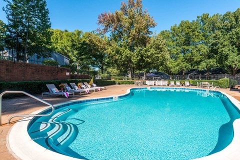 Swimming pool with lounge seating at Averly Apartments in Jonesboro, GA near Southlake Mall