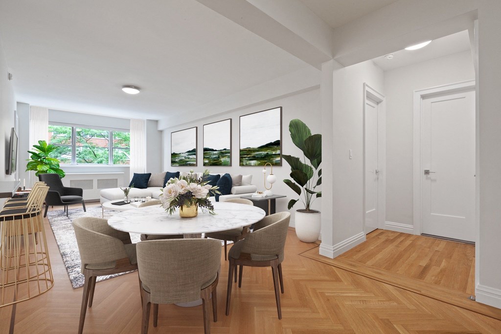 a living room and dining room with white walls and hardwood floors