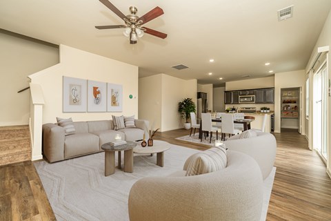 A modern living room with a beige sofa and a wooden coffee table.