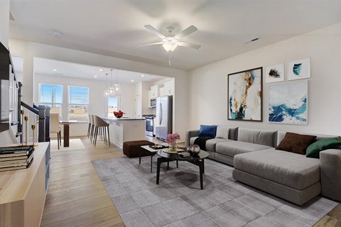 A modern living room with a grey sofa and a coffee table.
