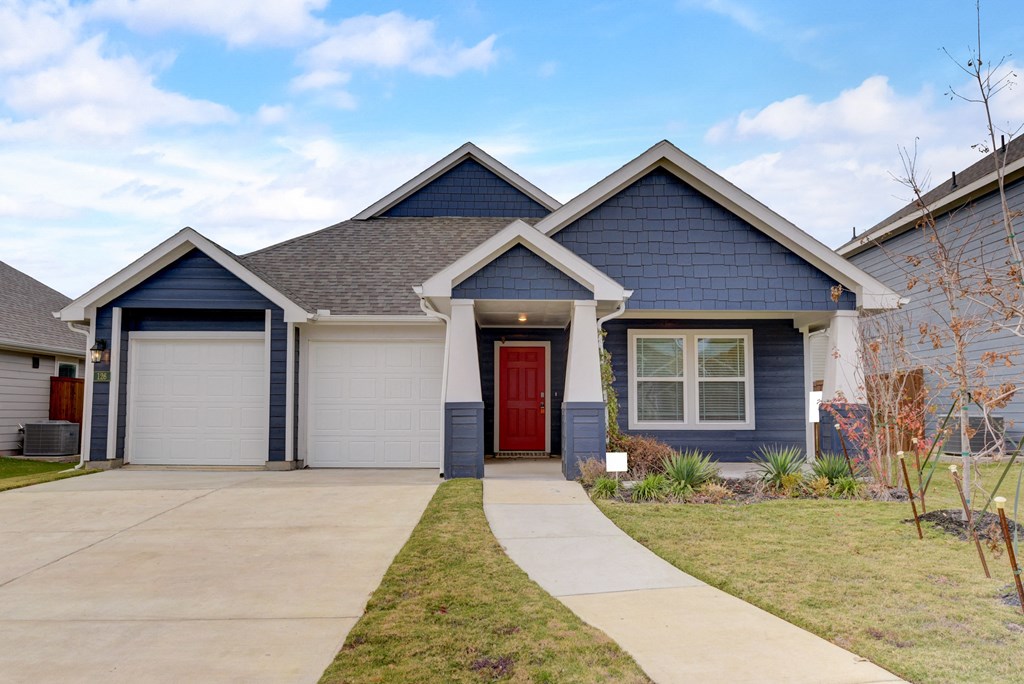 a house with blue siding and a red door