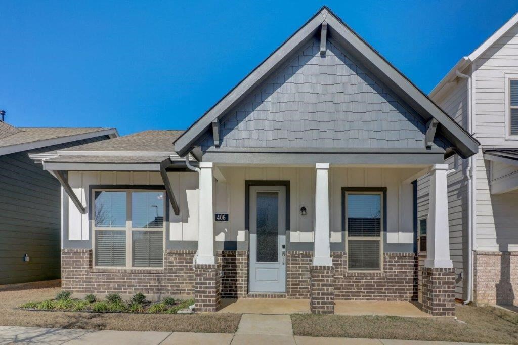 a brick house with a blue sky in the background
