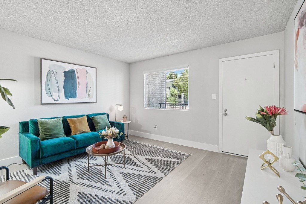 A living room with a green couch and a coffee table.