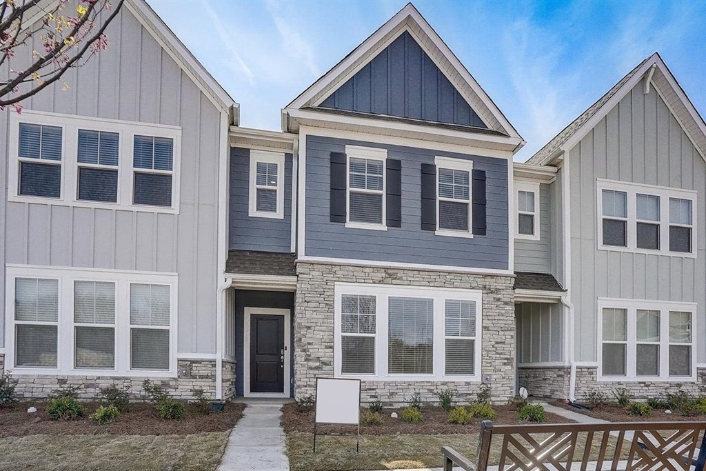 A modern house with a grey and blue exterior.