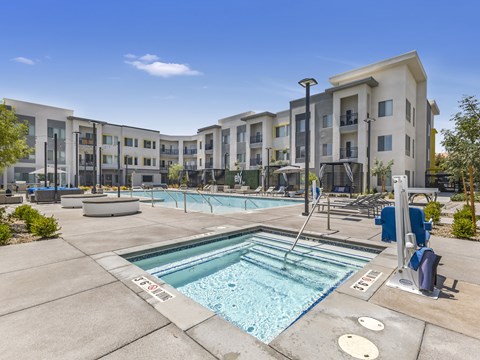 A swimming pool in front of apartment buildings.