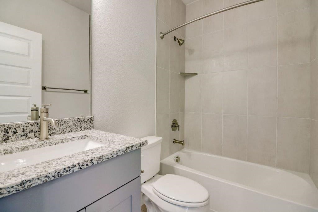 a bathroom with a sink toilet and a bath tub