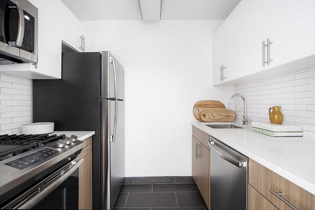 a kitchen with stainless steel appliances and a white counter top