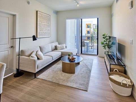 A living room with a white couch and a coffee table.