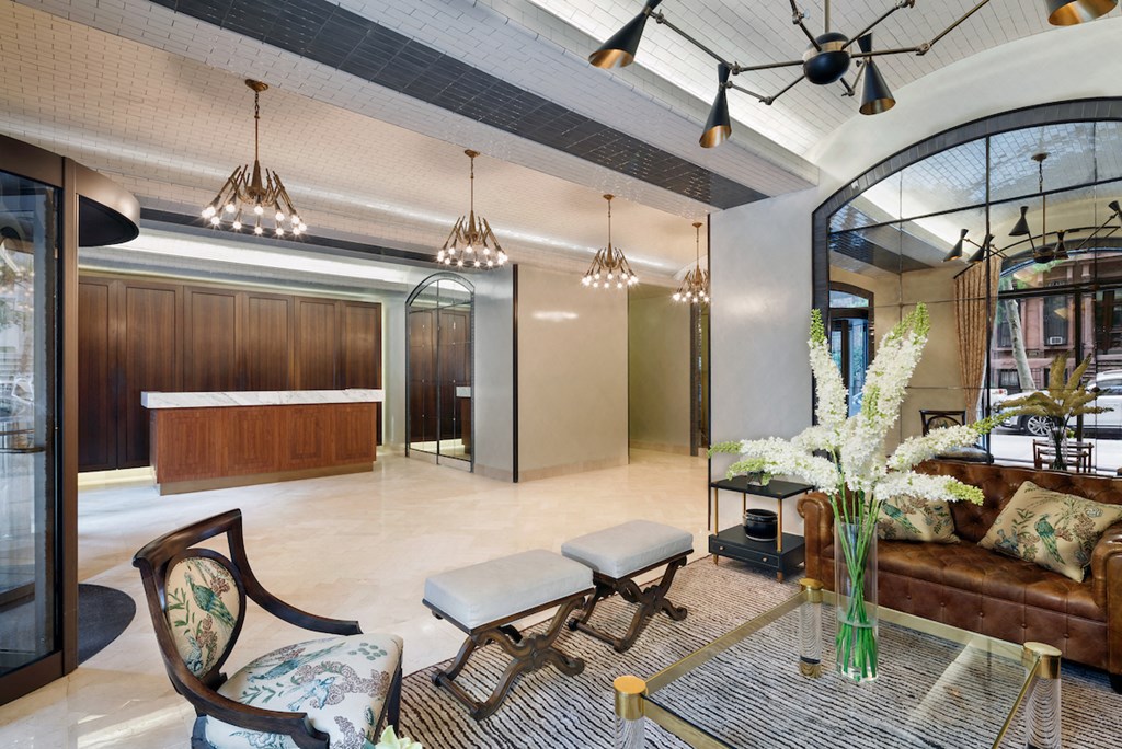 a lobby with a couch and chairs and a table