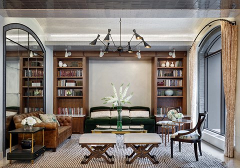 a living room with a green couch and a table