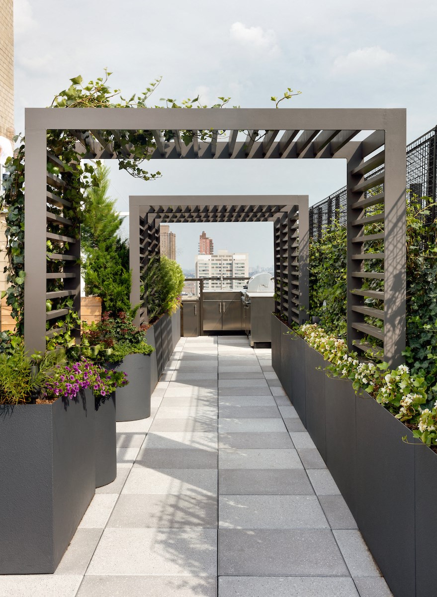 a pergola with a view of the city in the background